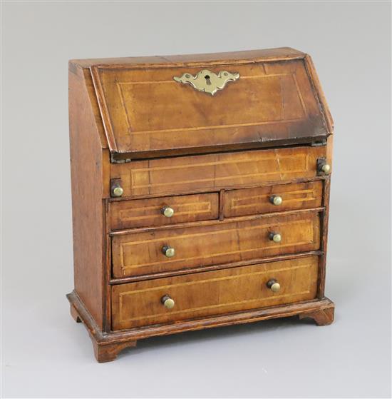 A mid 18th century style miniature walnut bureau, 9in., height 9.5in.